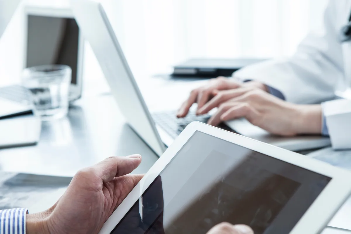 Enterprise team working with a tablet and laptop